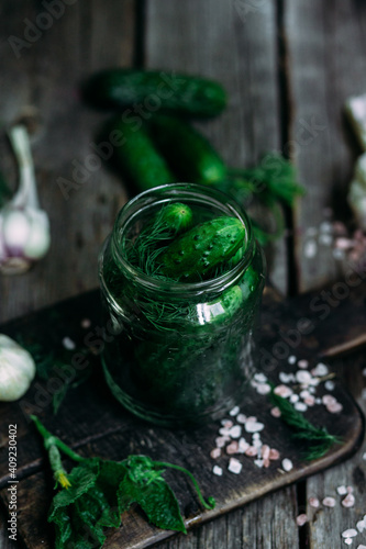 Fototapeta Naklejka Na Ścianę i Meble -  Cucumbers in a jar The process of pickling fresh cucumbers.