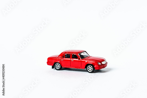 Red toy car on white isolated background