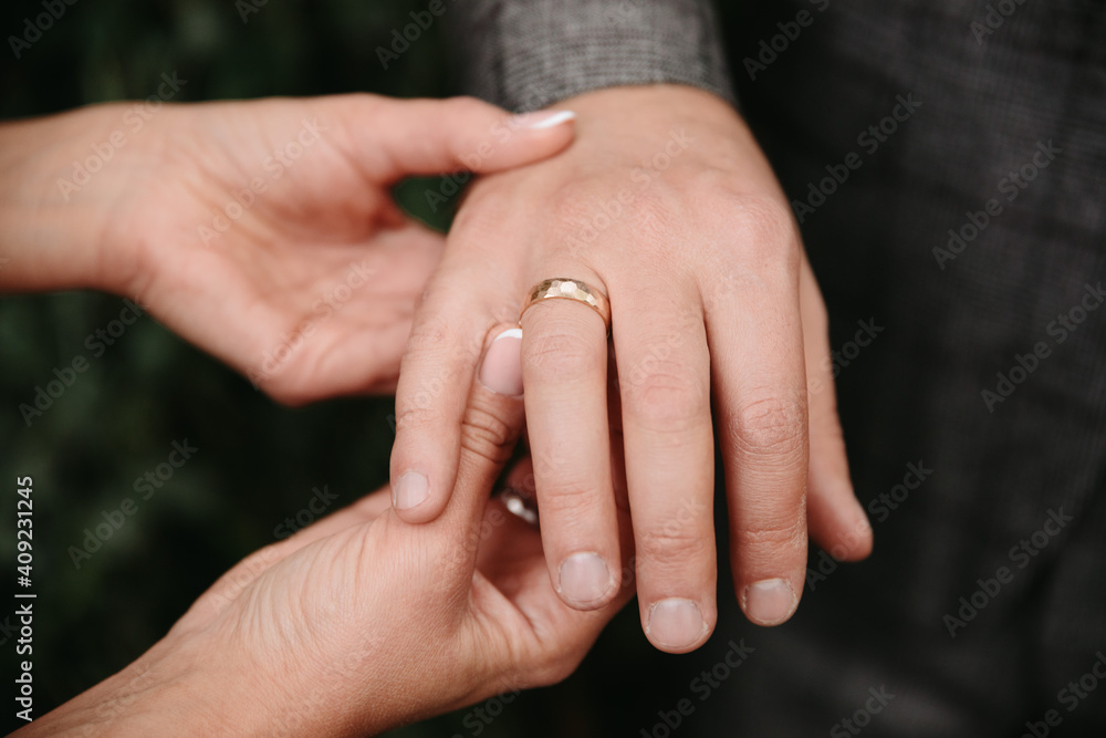 Holding hands with wedding rings. Bridal bouquet is held with bridal hands. Invitation to the wedding ceremony. Wedding rings. Flowers and shoes for the bride. Bridal shoes and jewellery Holding hands with wedding rings. Bridal bouquet is held with bridal hands. Invitation to the wedding ceremony. Wedding rings. Flowers and shoes for the bride. Bridal shoes and jewellery