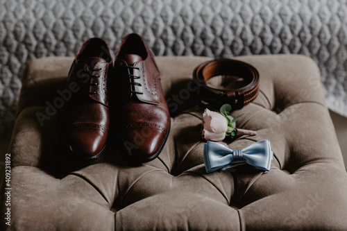 Grooms morning preparation. Handsome man getting dressed and preparing for the wedding, businessman checking time on his wrist watch, man putting clock on hand, groom getting ready in the morning