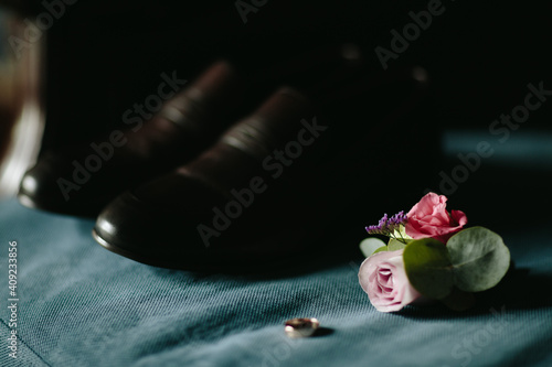 Grooms morning preparation. Handsome man getting dressed and preparing for the wedding, businessman checking time on his wrist watch, man putting clock on hand, groom getting ready in the morning photo