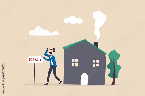 Home for sale, selling house moving to new home concept, home owner hammer for sale sign in front of his house.
