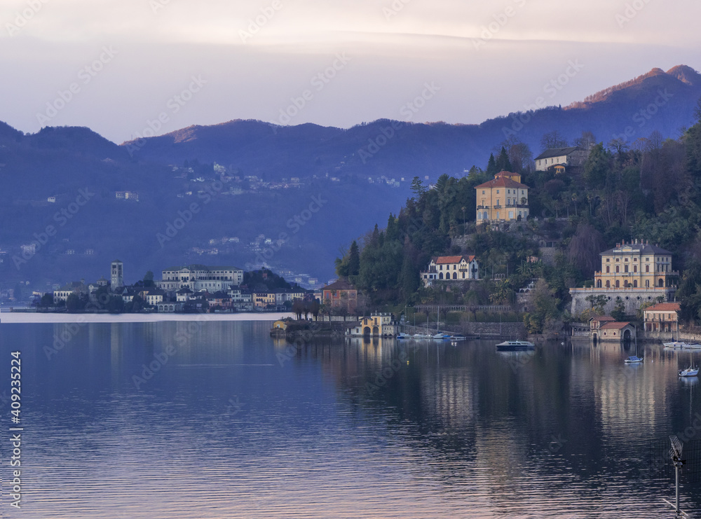 Landscape of Lake Orta, stunning villas on the slopes of the mountains that frame the island of San Giulio. Piedmont, Italian lakes, Italy.