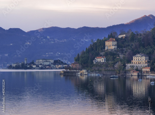 Landscape of Lake Orta, stunning villas on the slopes of the mountains that frame the island of San Giulio. Piedmont, Italian lakes, Italy.