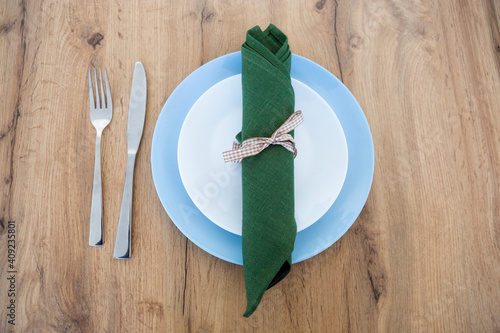 Fork,knife, green napkin with plate.
