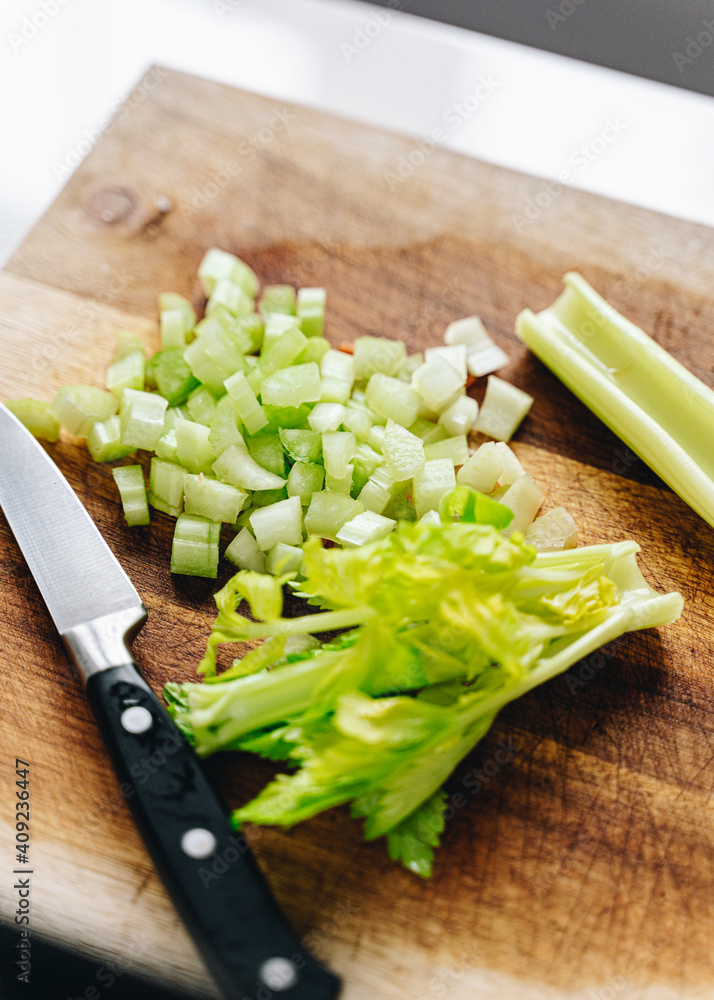 close up of chopped celery on wooden board close up of chopped celery on wooden board