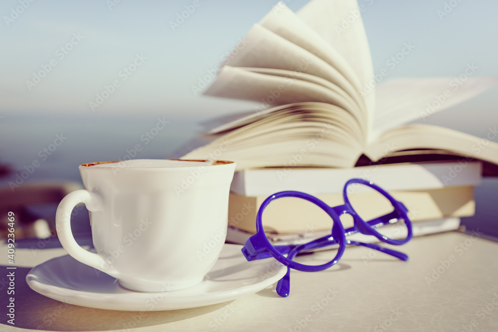 Coffee cup and books outdoors