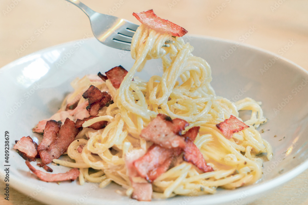 Spaghetti Carbonara with ham and bacon served on a dish. Spaghetti Carbonara with ham and bacon served on a dish.