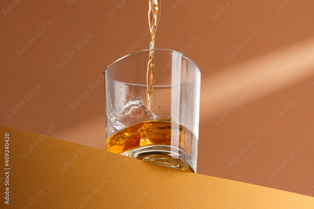 whiskey is poured into a glass