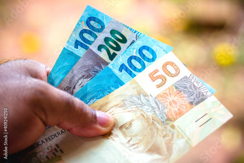 In this photo illustration the fifty and one hundred and two hundred reais banknotes is being displayed. The Real is the current money in Brazil.