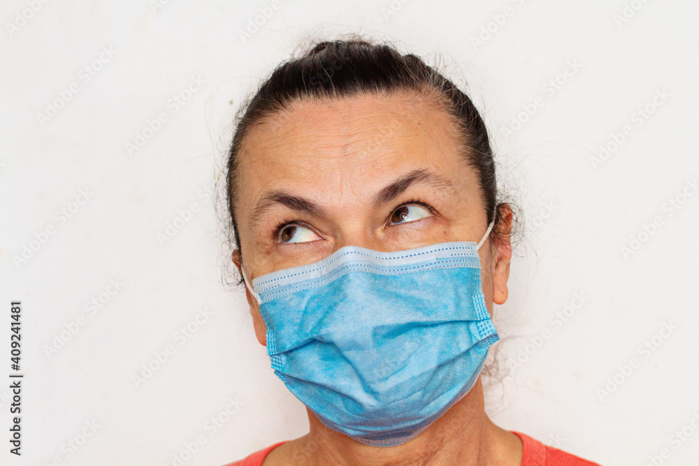 Woman aged in medical mask against coronavirus isolated on white rolled eyes Woman aged in medical mask against coronavirus isolated on white rolled eyes