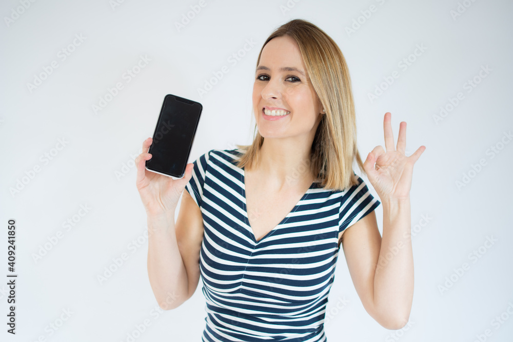 Young happy cheerful woman showing mobile phone over white background. Young happy cheerful woman showing mobile phone over white background.