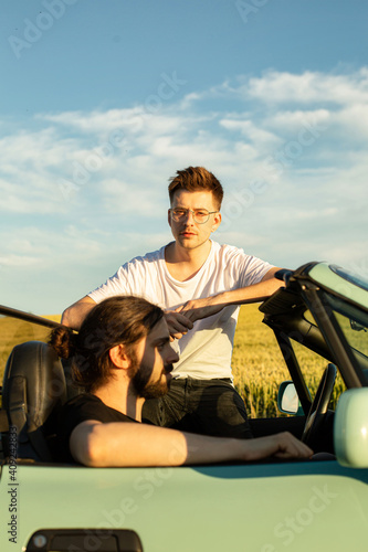 White european models sitting in the car two men