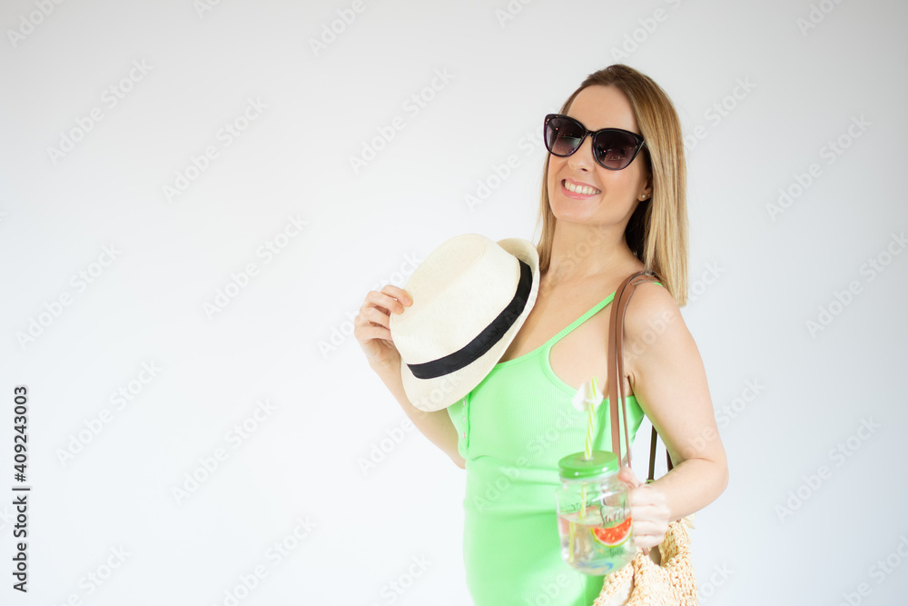 Portrait of gorgeous vacation woman wearing straw hat holding a cold drink isolated over white background. Portrait of gorgeous vacation woman wearing straw hat holding a cold drink isolated over white background.
