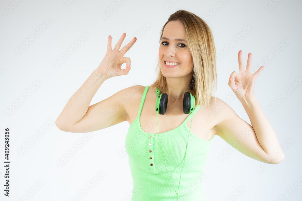 Fototapeta premium Happy young woman showing okay sign isolated over white background