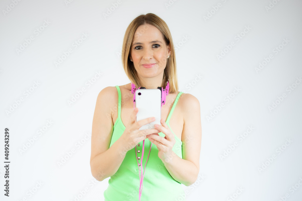 Portrait of a smiling young casual woman using mobile phone isolated over white background Portrait of a smiling young casual woman using mobile phone isolated over white background
