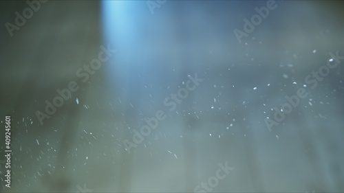 Obraz na plátně Small airborne particles moving around in the light