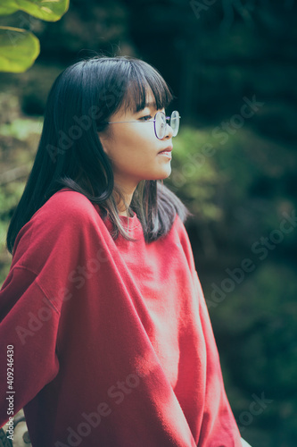 portrait of asian teenager wearing eyeglasses standing outdoor