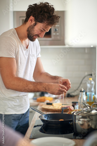 A young guy preparing a meal. Kitchen, food, home, cooking