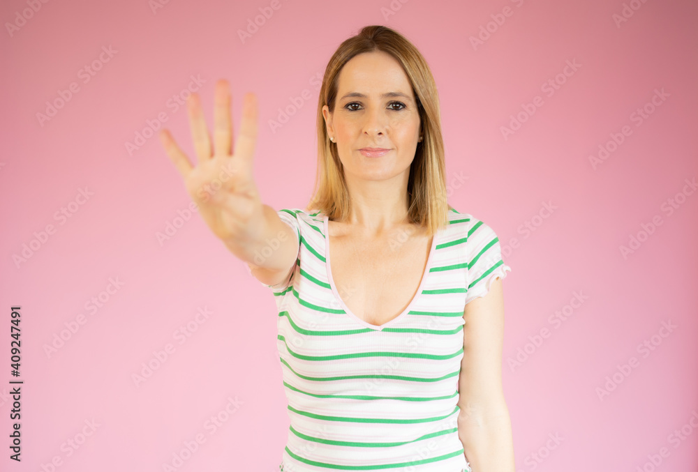 Young woman over isolated pink background happy and counting four with fingers Young woman over isolated pink background happy and counting four with fingers