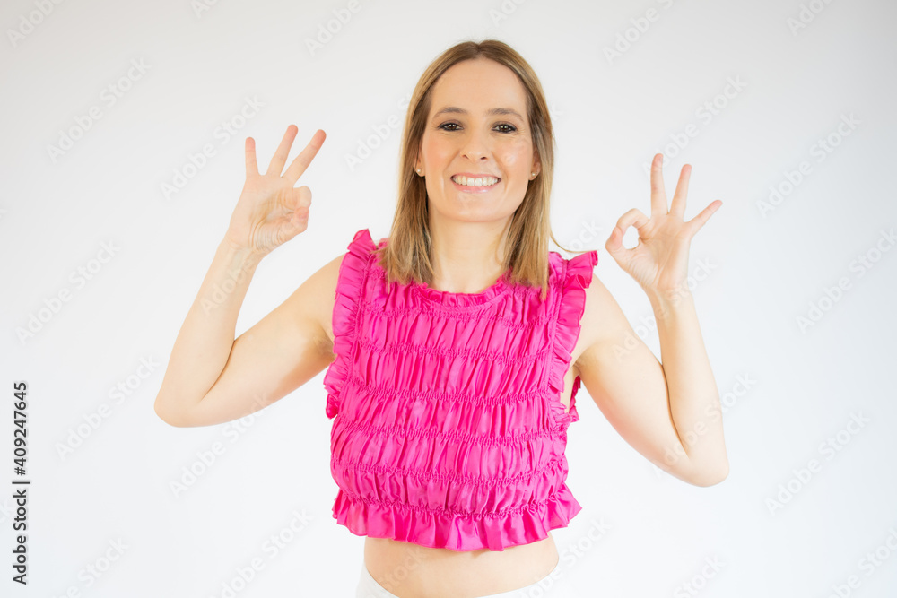 Happy young woman showing okay sign with fingers isolated over white background Happy young woman showing okay sign with fingers isolated over white background