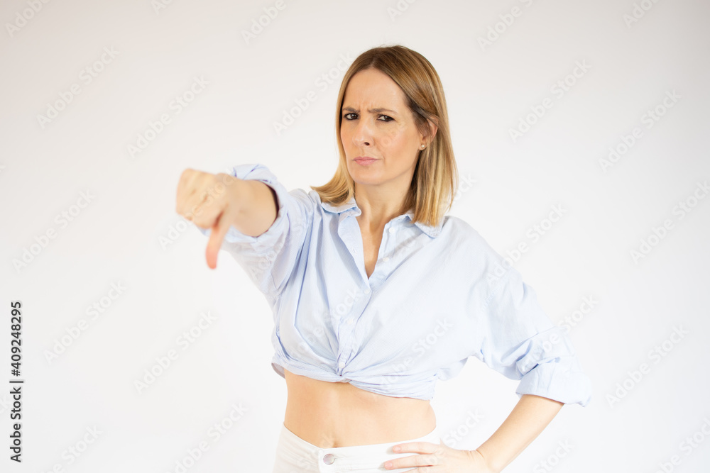 Young caucasian woman isolated on white background showing thumb down Young caucasian woman isolated on white background showing thumb down