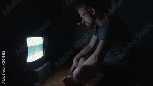 Old TV with man trying to fix it