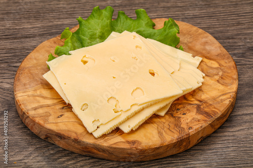 Sliced yellow cheese over board