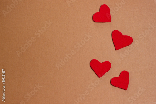 Red hearts on a beige background. The concept of Valentine's day