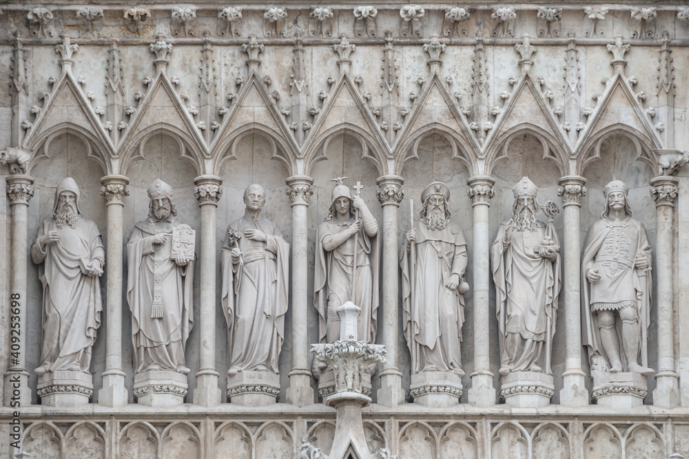 Religious scenes in wall sculptures of Votive Church in the historical and touristic downtown in Vienna, Austria