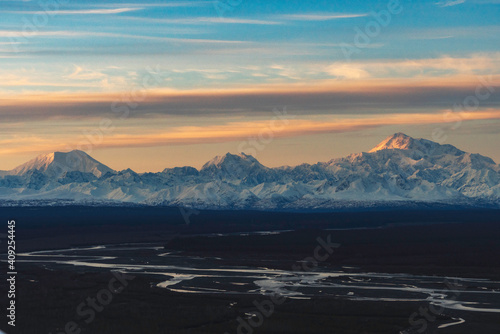 Aerial view of the sun setting on the high peaks of the Alaska Range photo