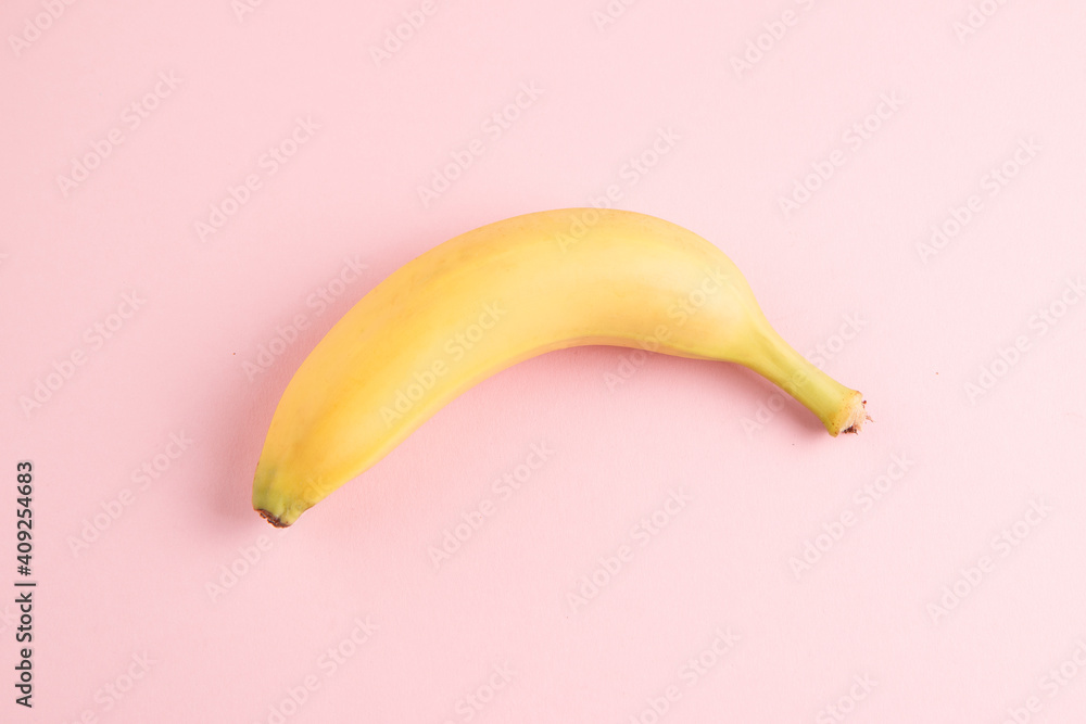 Banana on pink background close up Banana on pink background close up