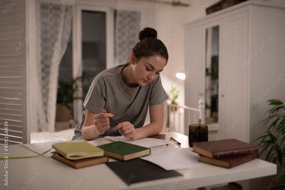 Student doing homework and reading notes Student doing homework and reading notes