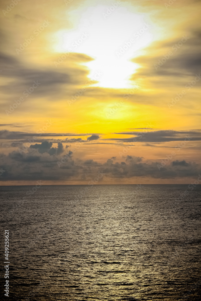 Obraz premium Dramatic sunset sky with clouds.Sunset ocean tranquil scene.Fantastic view of the dark overcast sky. Dramatic and picturesque everning scene.Fiery Backdrop Over Water