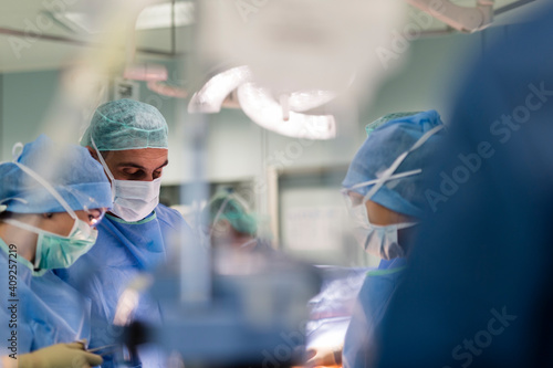 a surgeon in the operating room watching a patient