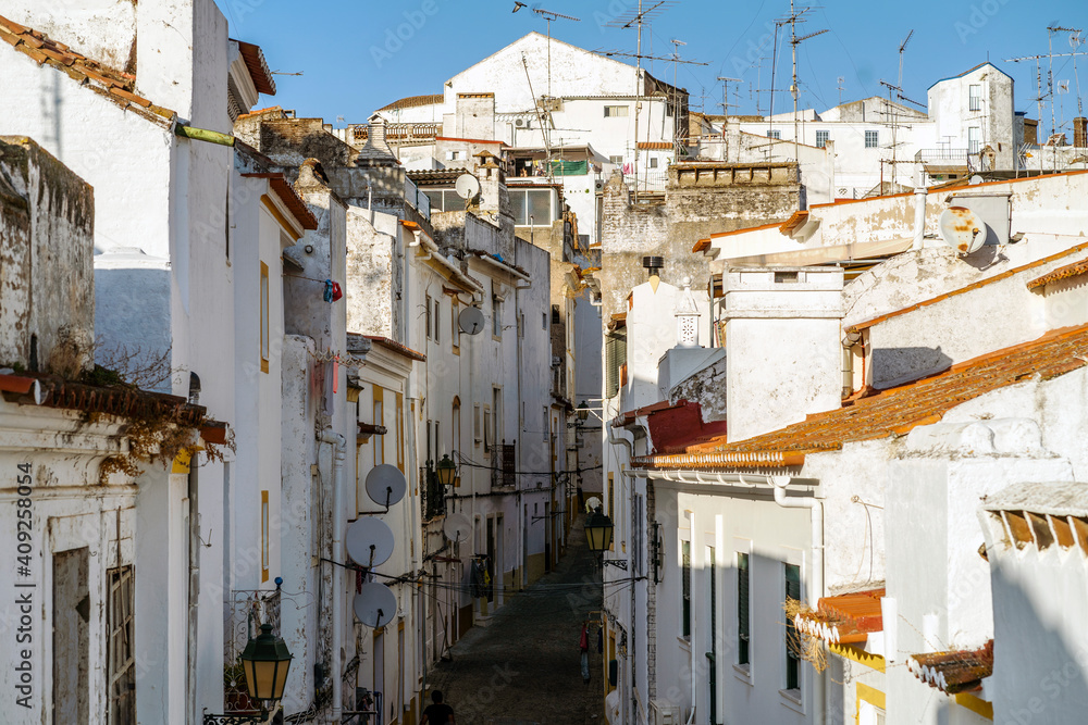 Narrow street between whitewash houses of Elvas, Alentejo, Portugal