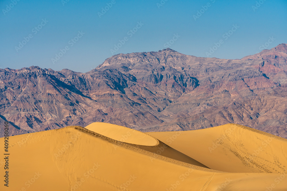 Scenic view of Mesquite Flat Sand Dunes and rocky mountains in desert, Death Valley National Park, California, USA Scenic view of Mesquite Flat Sand Dunes and rocky mountains in desert, Death Valley National Park, California, USA