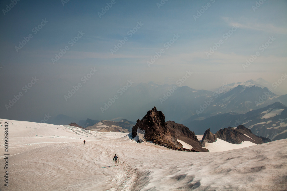 Two climbers descend from Glacier Peak in Washington. Two climbers descend from Glacier Peak in Washington.