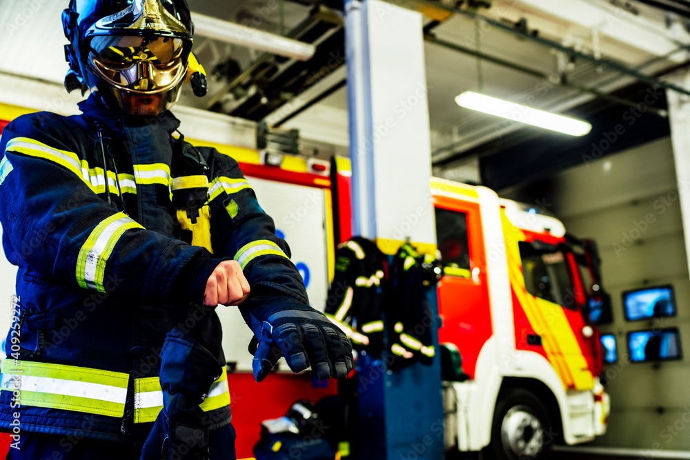 firefighter putting on gloves to go to an emergency firefighter putting on gloves to go to an emergency