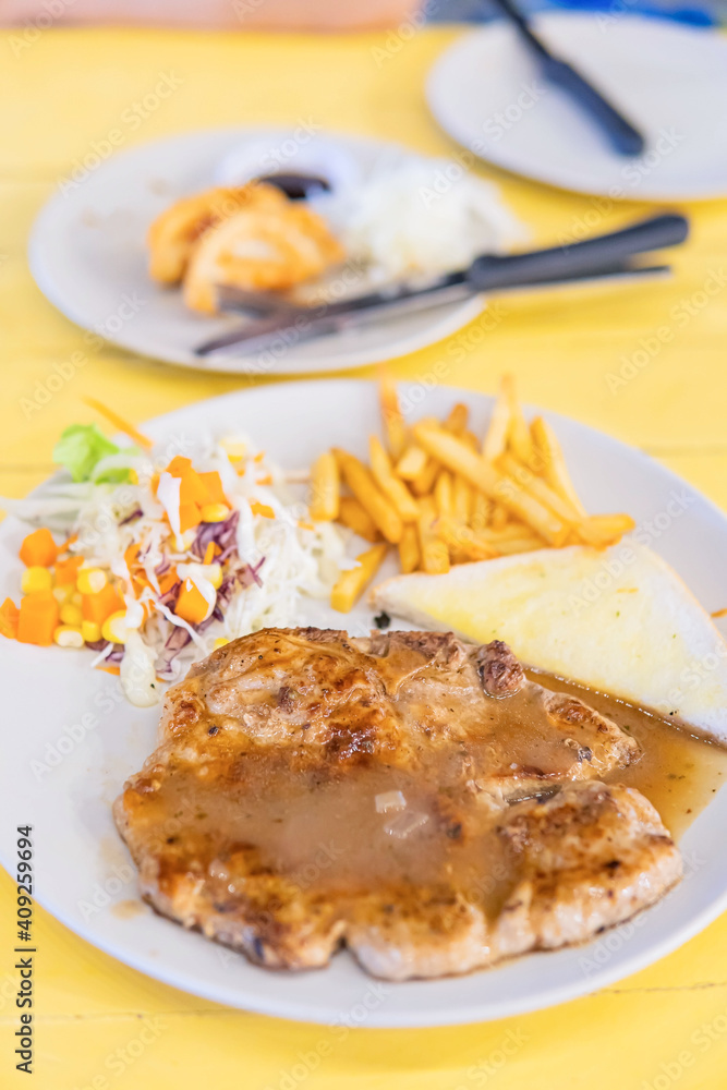 Grilled Pork Steak Wit French Fries On Dish Grilled Pork Steak Wit French Fries On Dish