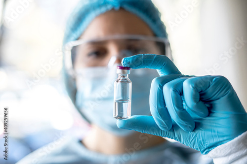 Medical doctor or laborant holding tube with nCoV Coronavirus vaccine for 2019-nCoV virus. photo