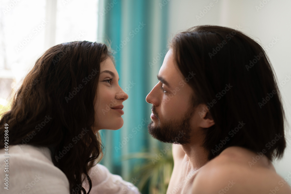 Beautiful couple looking at each other with love and smile Beautiful couple looking at each other with love and smile