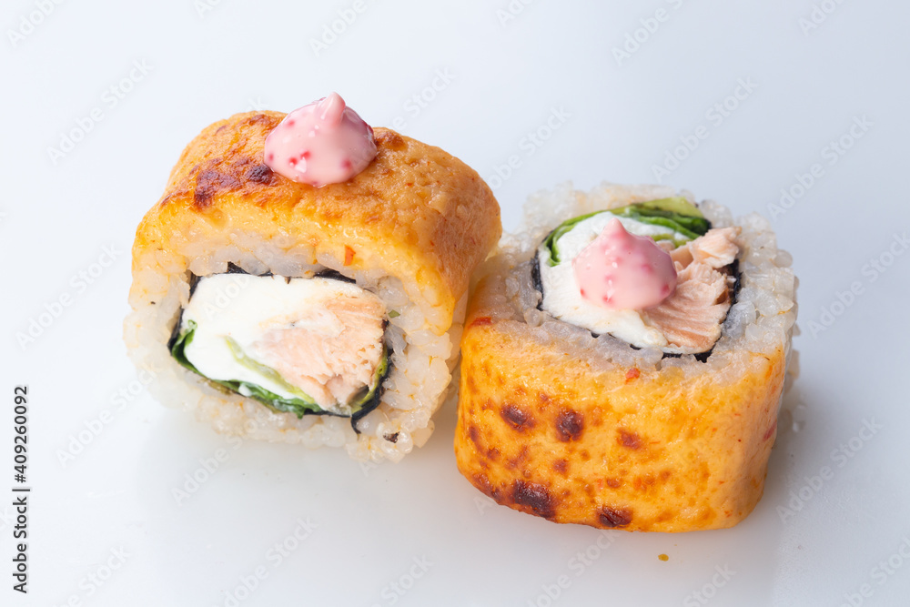 traditional Japanese cuisine. japanese sushi isolated on white background. maki sushi with salmon, cucumber, soft cheese (Philadelphia). baked sushi. hot sushi