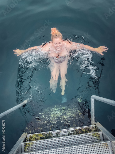 Smiling Woman in her 30s Floating in Cold Water Copenhagen Denmark photo