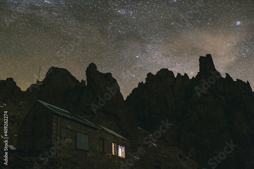 Galayos refuge against granite spikes and Milky Way during a winter night, Gredos, Spain