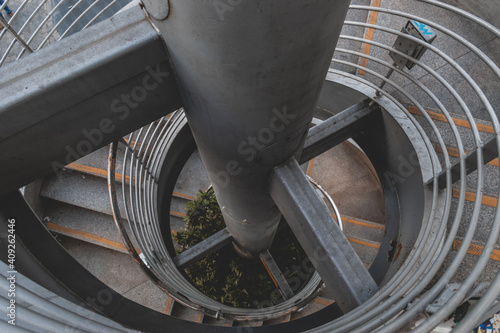 Fotografi Spiral staircase from top to bottom from concrete and metal