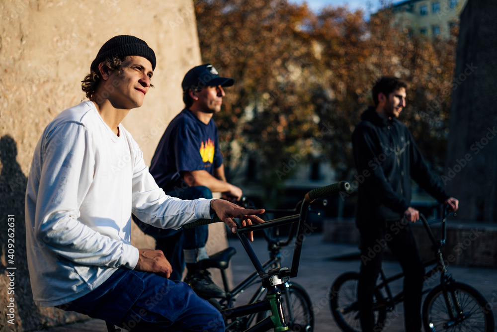 Three men posing with their bmx bikes in the city of Madrid Spain Three men posing with their bmx bikes in the city of Madrid Spain