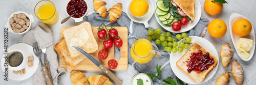 Delicious fresh breakfast served with drinks, croissants and fruits.