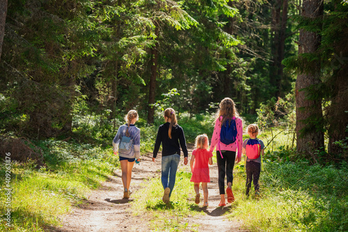 Children walking on footpath in a summer forest