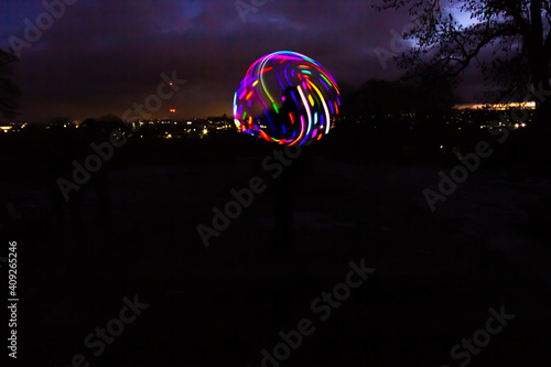 Fototapeta Silhouette Circus Model in Queens Park Bolton at Night in the Snow with Light Tr